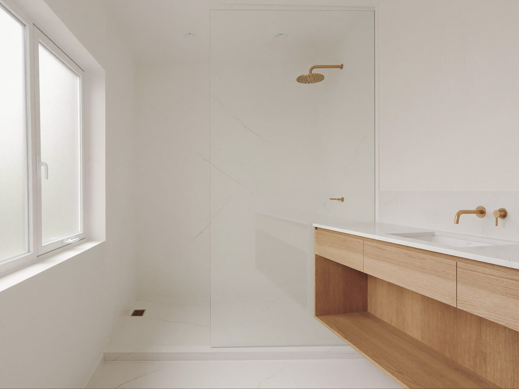 Modern bathroom with a walk-in shower and oak vanity