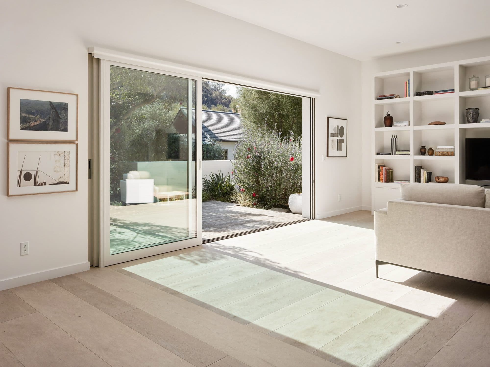 Open living room with built-in shelving and warm light